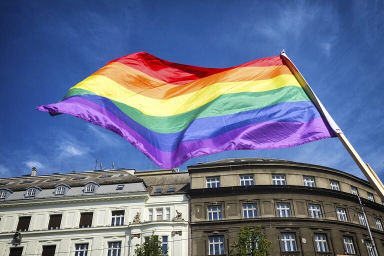pride flag flying over buildings